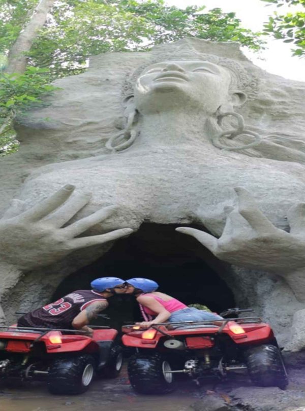 Keepall Bali ATV Adventure, bali atv, atv bali, bali atv ubud, ubud atv, Rider entering the hidden cave, Bali forest trail during ATV adventure, Group exploring muddy paths on ATVs, ATV parked near a Balinese rice field
